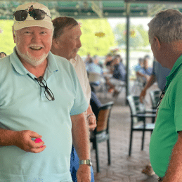 Smiling participants at golf tournament